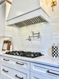 Contemporary kitchen with a gas stove, white backsplash, ProlineRangeHoods.com sleek hood, pot filler, and utensil inserts.