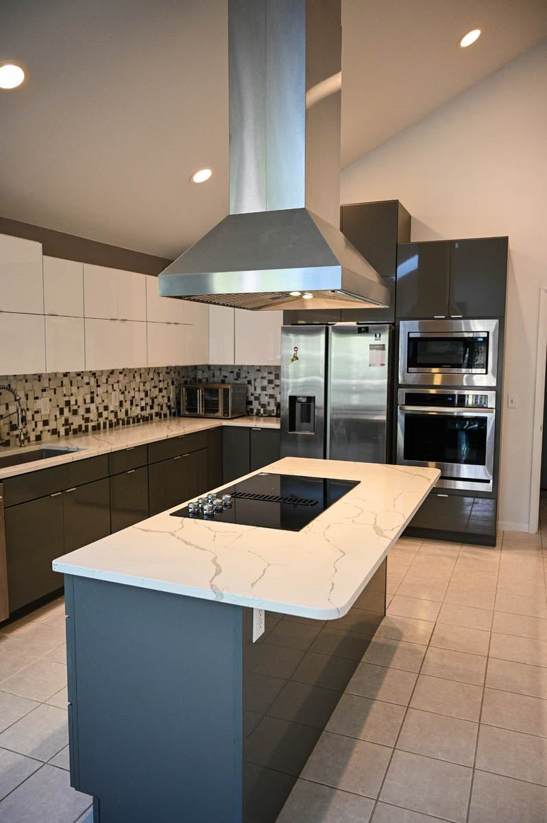 Contemporary kitchen with marble island, ProlineRangeHoods.com PROSI Island Range Hood, stainless steel appliances.