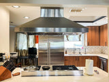 Modern kitchen with ProlineRangeHoods.com PROSI Island Hood, 900/1800 CFM, stove, wood cabinets, and double-door fridge.