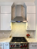 Modern kitchen featuring ProlineRangeHoods.com 30-36" Wall Mounted Range Hood, white cabinets, hex tile backsplash, and gas stove.