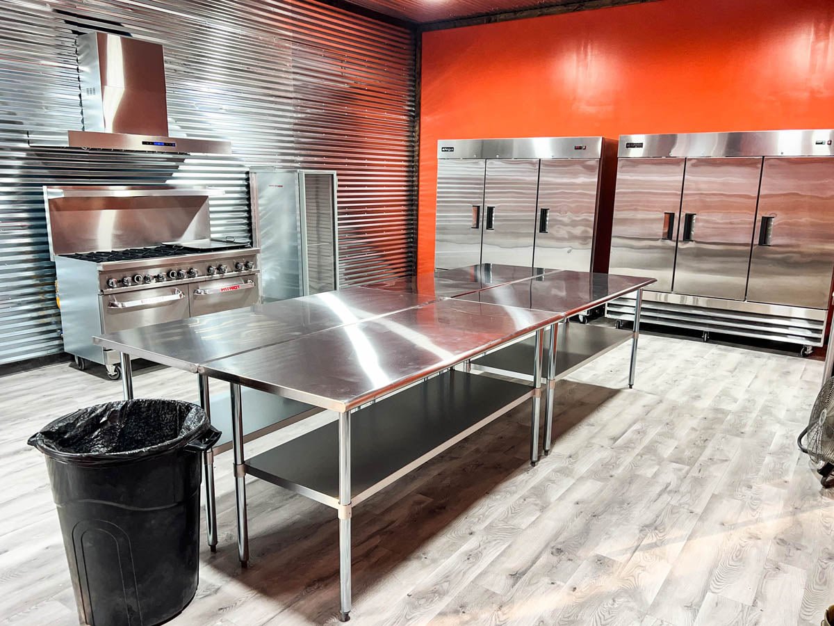 This commercial kitchen at ProlineRangeHoods.com features a sleek Proline Range Hood with 1100 CFM airflow and LCD controls.