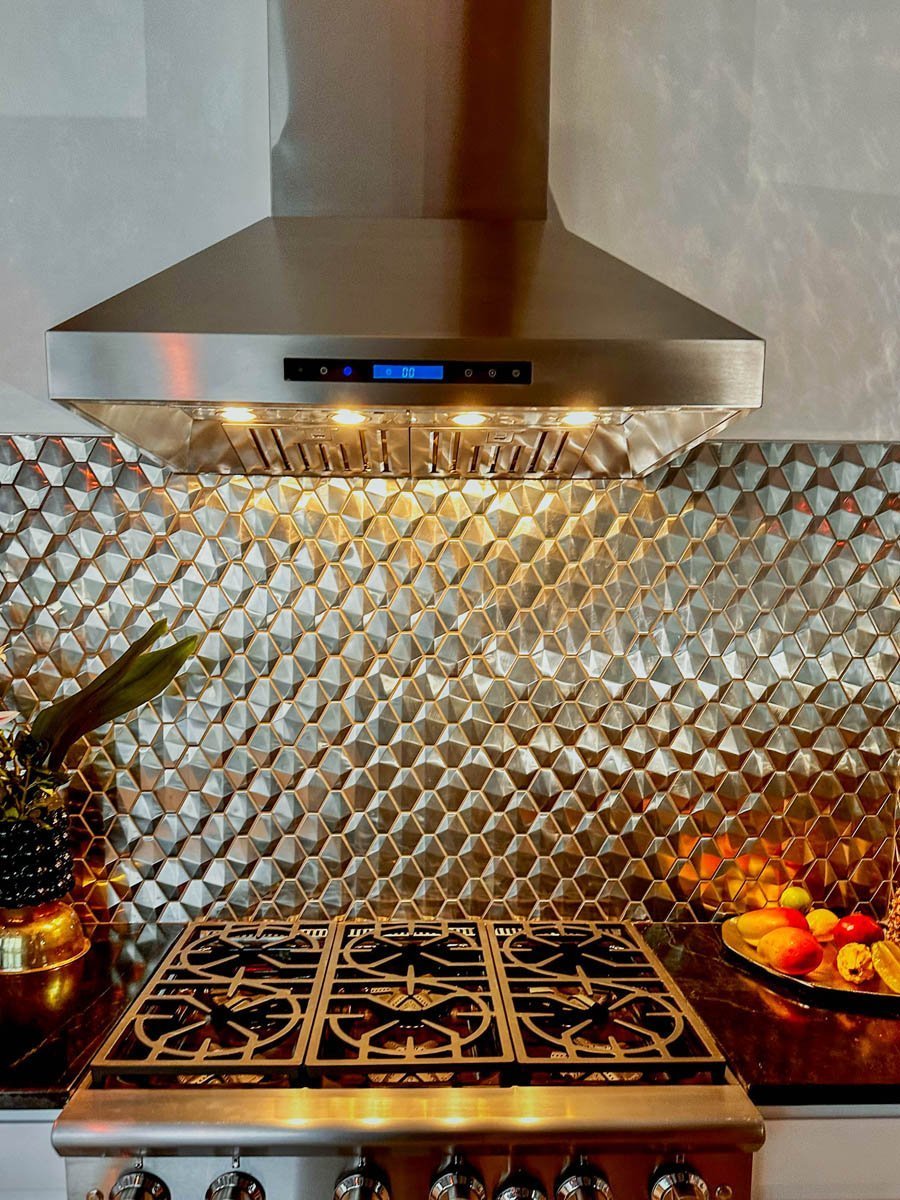 Contemporary kitchen with 1800 CFM stainless range hood from ProlineRangeHoods.com, a geometric backsplash, and black stove.