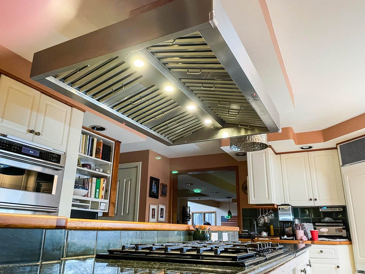 Check out a modern kitchen at ProlineRangeHoods.com featuring the Proline PLJI 103 Island Range Hood with a sleek finish.