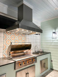 Outdoor kitchen with ProlineRangeHoods.com Island Range Hood, 1200 CFM dual motors, stainless steel finish, and grill.