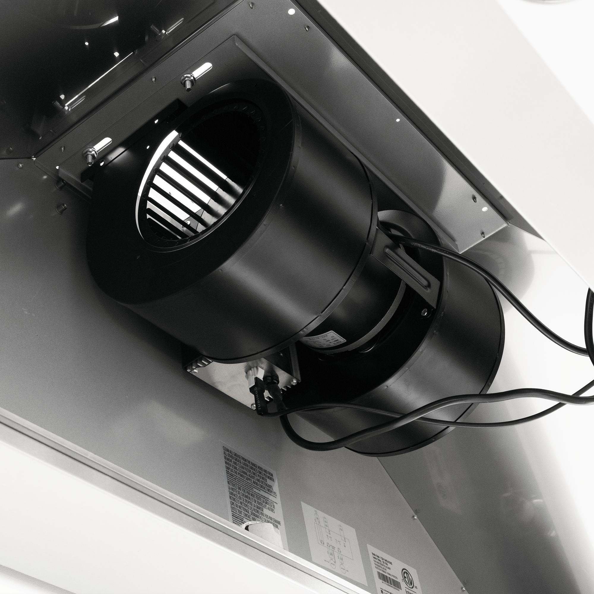 Close-up of a black dual blower fan (1200 CFM) in outdoor 304 stainless steel, labels, wires—ProlineRangeHoods.com.