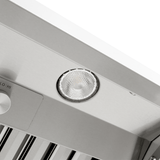 Round light fixture on Proline Range Hoods PLGW 104 HE in stainless steel, control knob visible. ProlineRangeHoods.com.