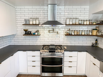 Customer kitchen with the Proline PLFW 520 - Wall-Mounted Range Hood, 600/1200 CFM | Convertible to Ductless, Stainless Steel, Matte Black Finish