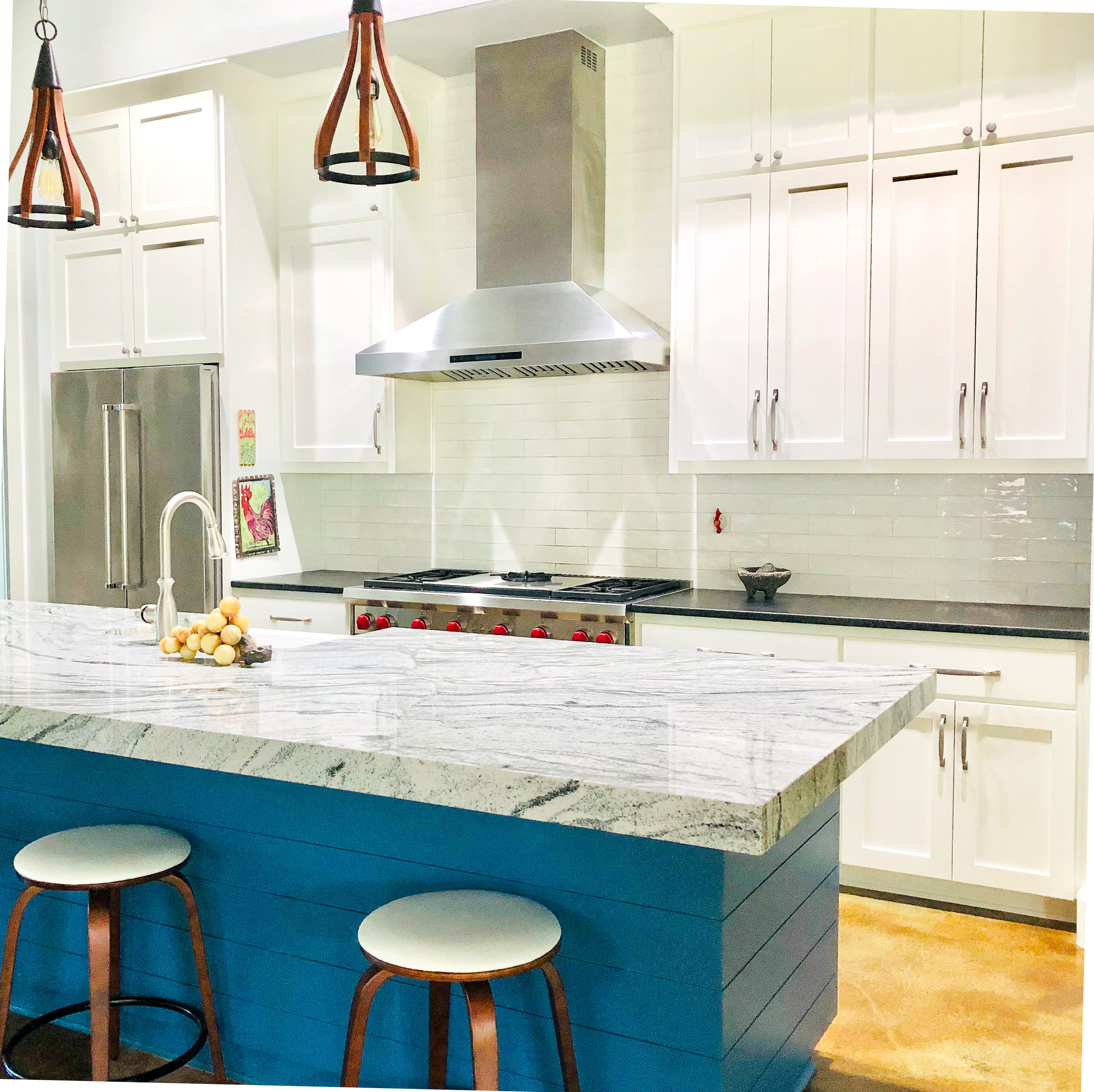 PLSW ProS Wall Mount Range Hood from ProlineRangeHoods.com above a gas stove in a white kitchen.