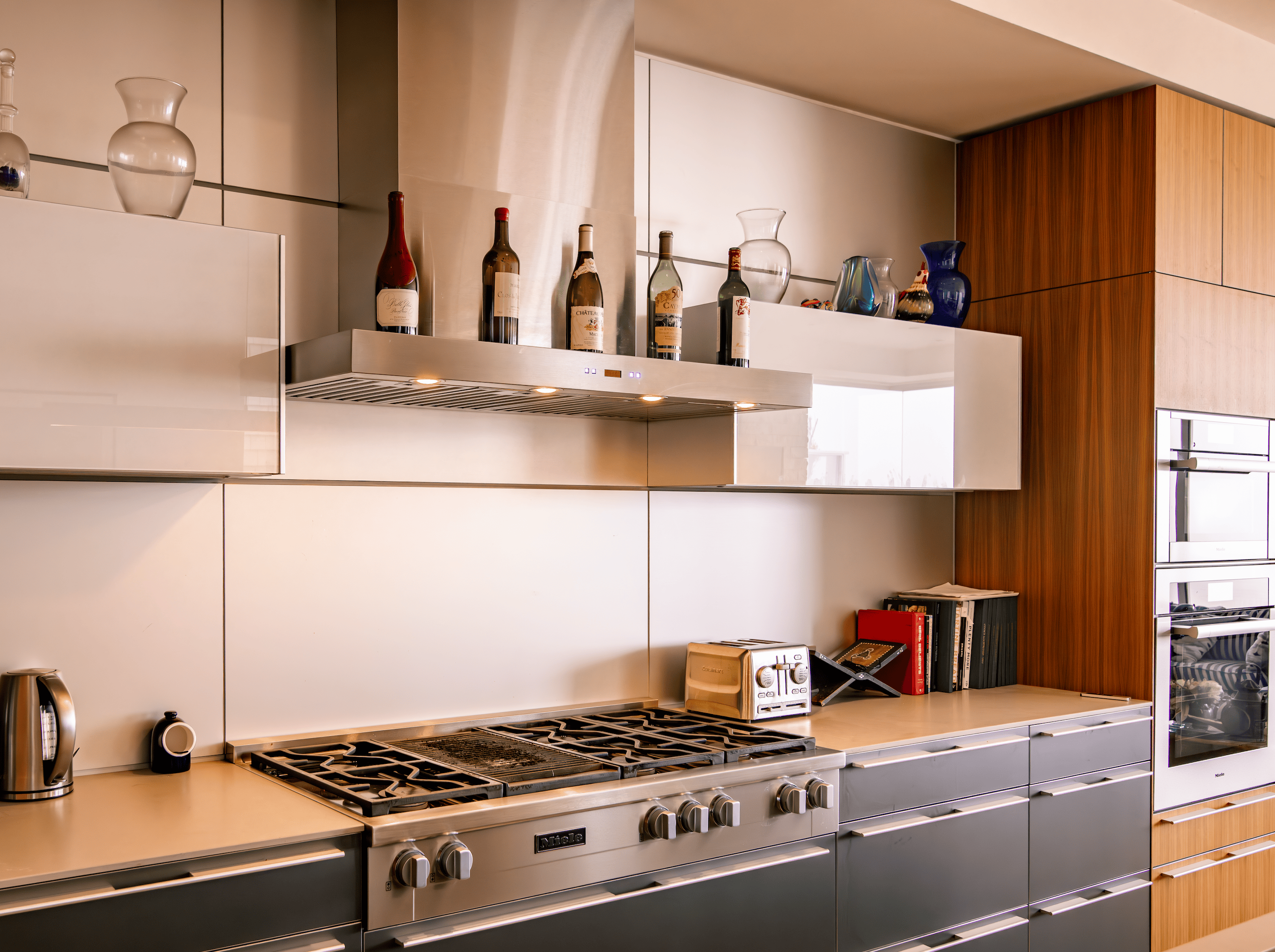 Proline PLFW 750 wall-mounted stainless steel range hood from ProlineRangeHoods.com above a gas cooktop.