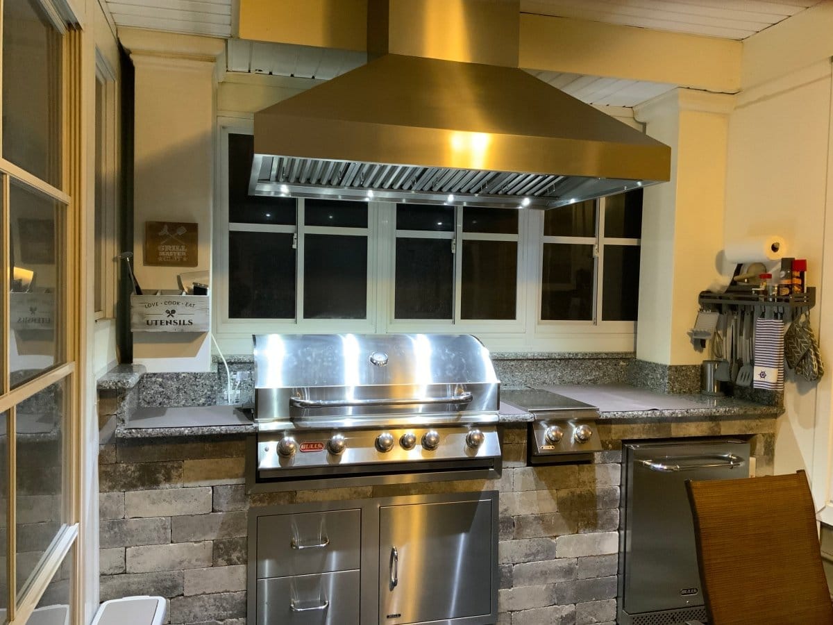 Modern kitchen with ProlineRangeHoods.com PLGI BBQ Ultra Island—304 steel, 2000 CFM, outdoor power indoors.