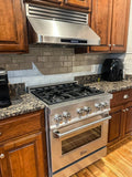Modern kitchen with a stainless stove, ProlineRangeHoods.com PLFW 115 range hood, wood cabinets, granite countertops. PLFW 115.30