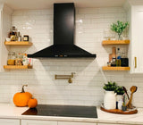 Modern kitchen with a ProlineRangeHoods.com Wall Mounted Range Hood, single motor, black finish, tile backsplash, pumpkins.