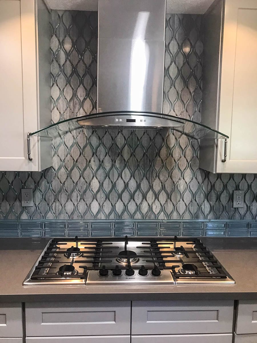 Modern kitchen with a gas stove, tile backsplash, and Proline PLFW 544 wall hood (600 CFM) from ProlineRangeHoods.com.