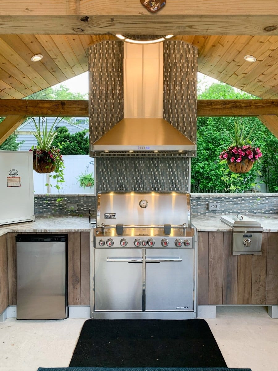 Experience the ultimate outdoor kitchen with ProlineRangeHoods.com, featuring a stainless grill and powerful Proline PLJW 129 Hood.