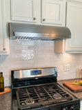 A modern kitchen features a ProlineRangeHoods.com PLJW 133 hood, 900 CFM, ductless with white cabinets and subway tiles.