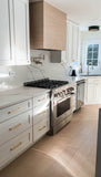 Modern kitchen with 430 stainless steel appliances, white cabinets, gold handles, and marble countertops. ProlineRangeHoods.com features a Proline Range Hoods 28, 34-inch insert/liner in stainless steel with dishwasher-safe filters for easy maintenance, capable of up to 1200 CFM.