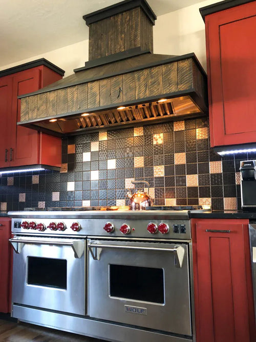 Stainless steel stove with red knobs, checkered tile backsplash, red cabinets in a ProlineRangeHoods.com kitchen.