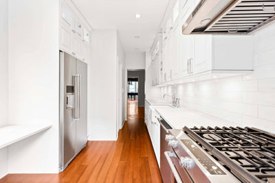 Customer kitchen with the Proline PLJW 113 - Under Cabinet Vent Hood, 900 CFM | Convertible to Ductless, Stainless Steel with Modern Control Panel