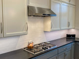 PLSW 116 stainless steel under-cabinet range hood above a gas cooktop. ProlineRangeHoods.com.