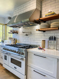 Proline PLJW 109 stainless steel range hood above a white gas stove. See ProlineRangeHoods.com.