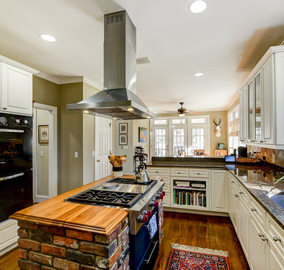 Customer kitchen with the Proline PLFI 520 - Ducted Island Range Hood, 600/1100 CFM | Stainless Steel Finish