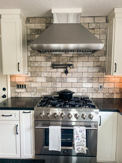 Customer kitchen with the Proline PLJW 109 WC - Ducted Wall-Mounted Range Hood, 1200 CFM | Stainless Steel Finish, Outdoor Rated
