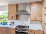 Proline PLGW 129 SC stainless steel range hood above a gas stove. Details at ProlineRangeHoods.com.