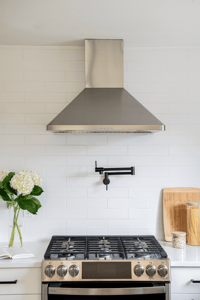 Customer kitchen with the Proline PLJW 129 - Ducted Indoor/Outdoor Wall-Mounted Range Hood, 900/1200 CFM | Stainless Steel Finish