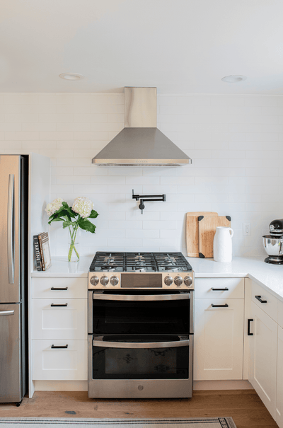 Customer kitchen with the Proline PLJW 129 - Ducted Indoor/Outdoor Wall-Mounted Range Hood, 900/1200 CFM | Stainless Steel Finish