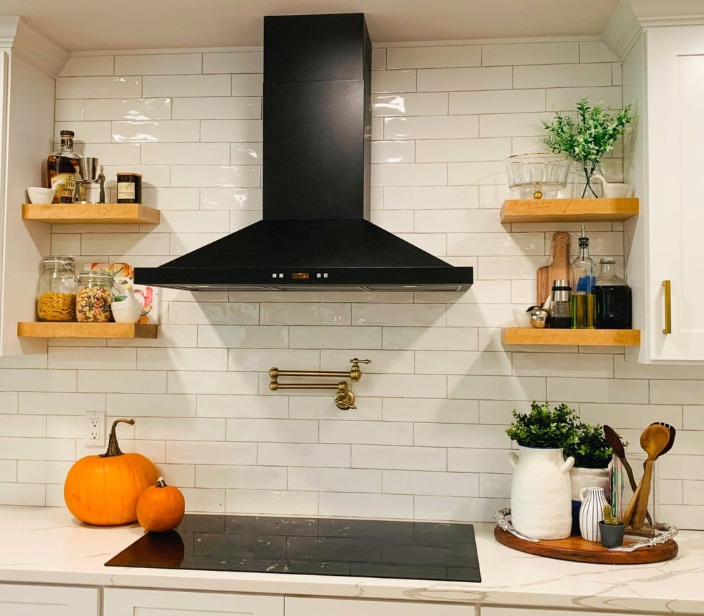 Modern kitchen with a ProlineRangeHoods.com Wall Mounted Range Hood, single motor, black finish, tile backsplash, pumpkins.