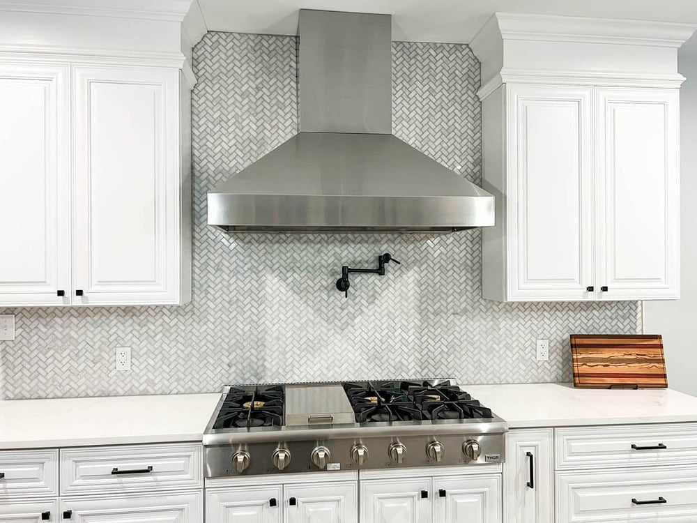 Modern kitchen with white cabinets, cutting board, Proline Range Hood PLJW 104—1200 CFM. ProlineRangeHoods.com.