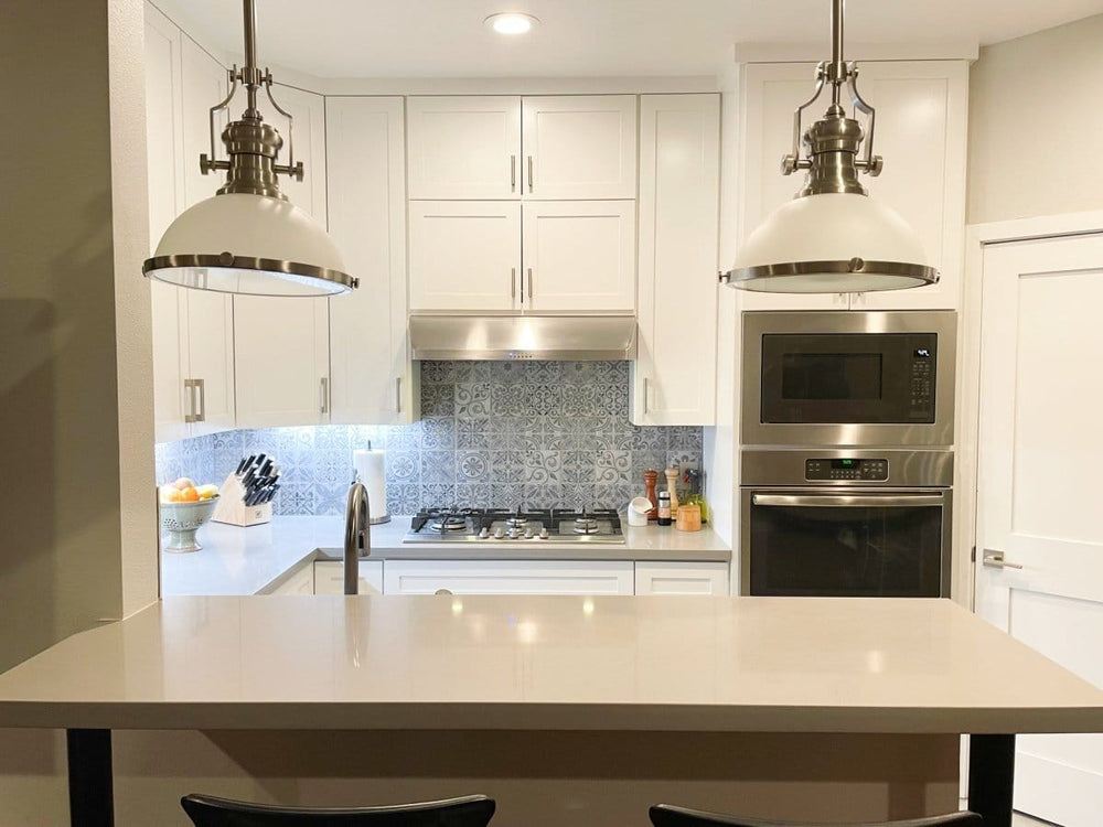 In a modern kitchen with white cabinets and ProlineRangeHoods.com, the PLJW 125 offers quiet, efficient 900 CFM performance.