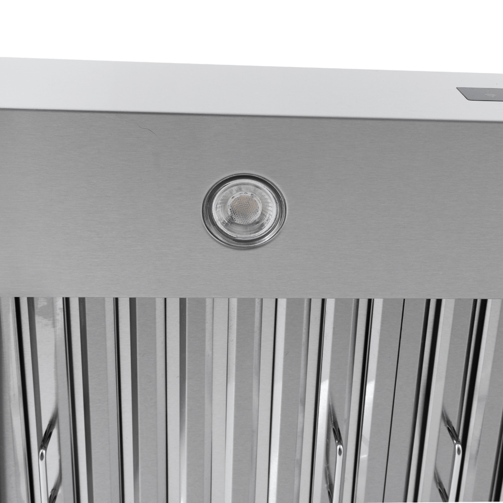 Proline PLJW 130 wall-mounted range hood in stainless steel, with round light and vent slats. ProlineRangeHoods.com.