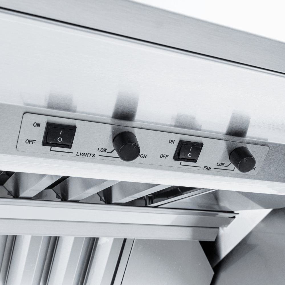 Close-up of Proline ProVI range hood control panel, switches and knobs, stainless steel finish. ProlineRangeHoods.com.